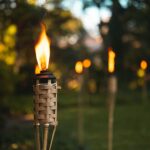 a lighted torch on wooden stand