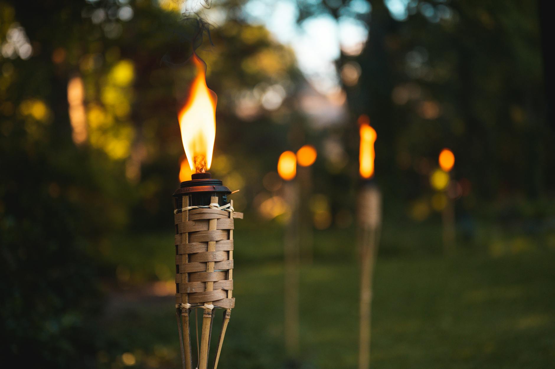 a lighted torch on wooden stand