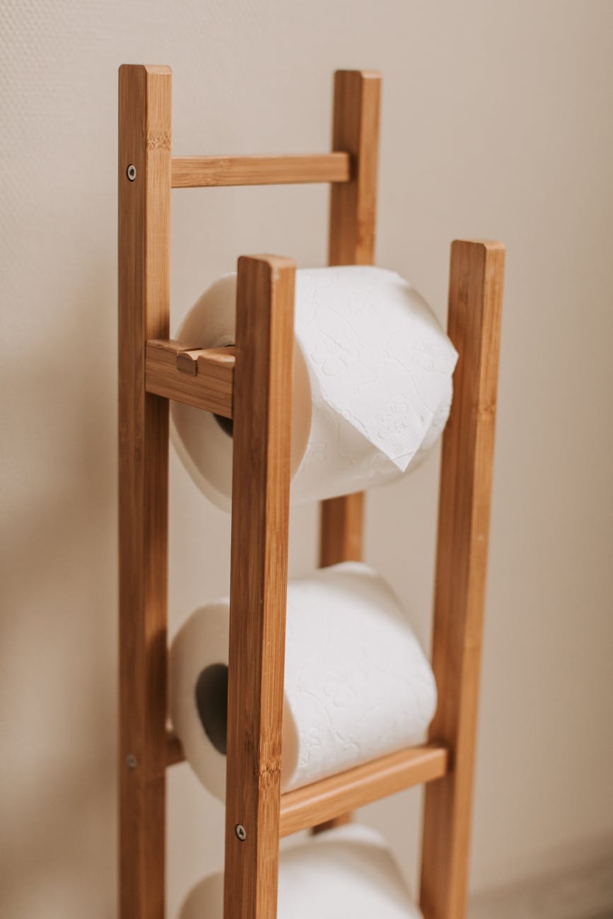 toilet paper rolls on brown wooden rack